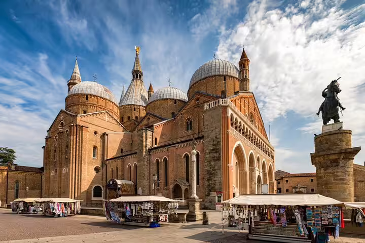 Basilica of Saint Anthony in Padua with equestrian statue and market stalls in the foreground