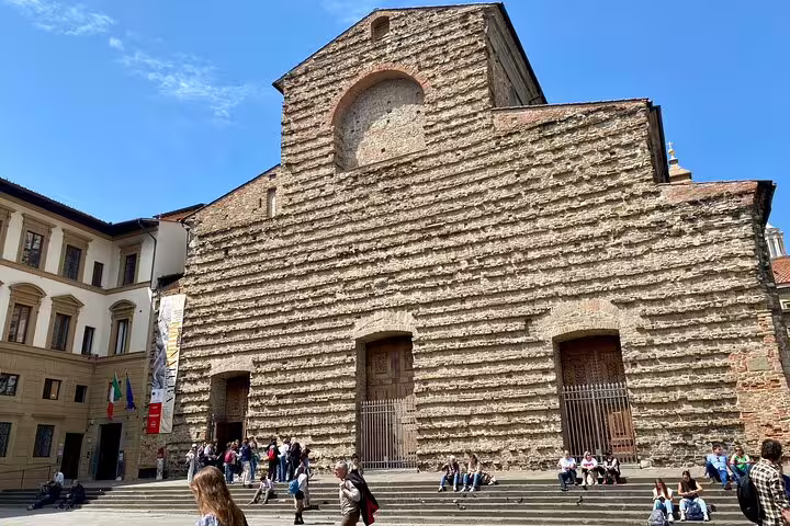 Historic Basilica di San Lorenzo facade with tourists on steps during a Florence sightseeing walking tour