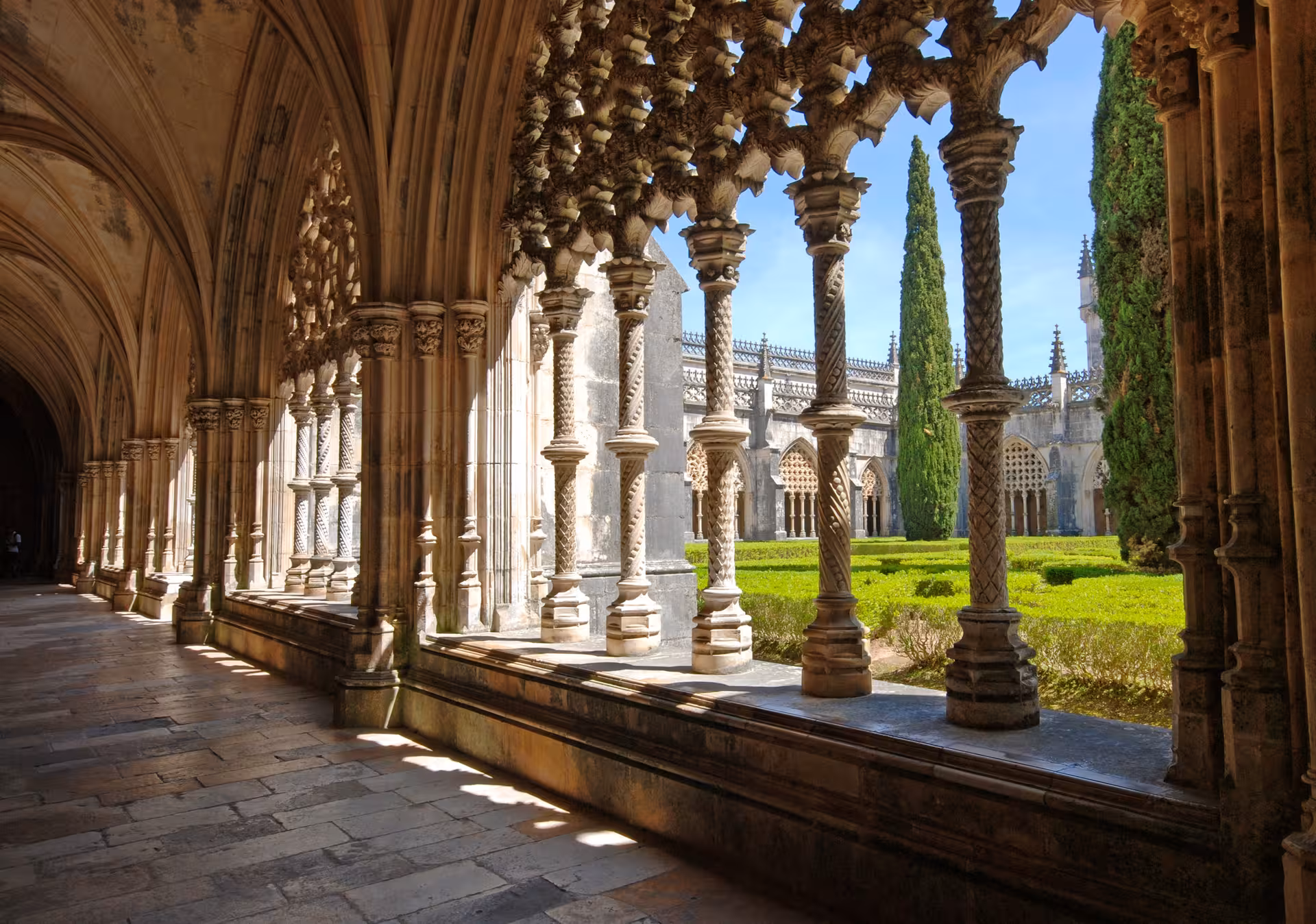 Intricate Gothic architecture of Batalha Monastery's cloisters, showcasing Portugal's historical beauty.