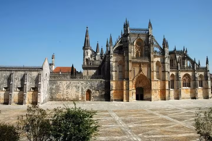 Side view of Batalha Monastery highlighting its Gothic design, a key attraction for private tours in Portugal.