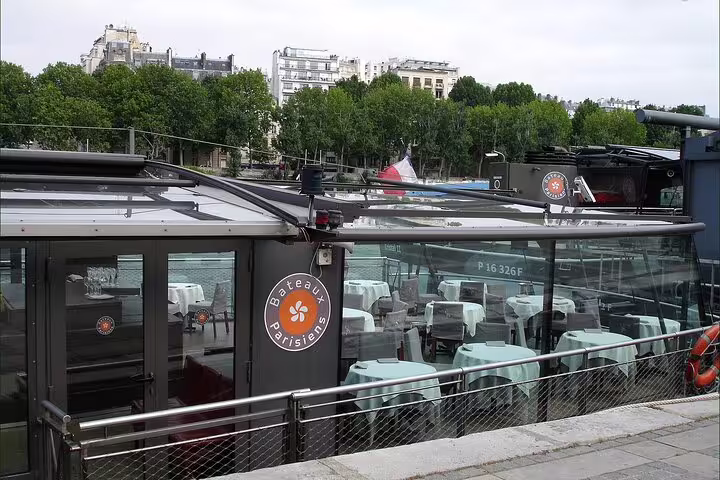 Bateaux Parisiens restaurant boat on the Seine River in Paris with set dining tables