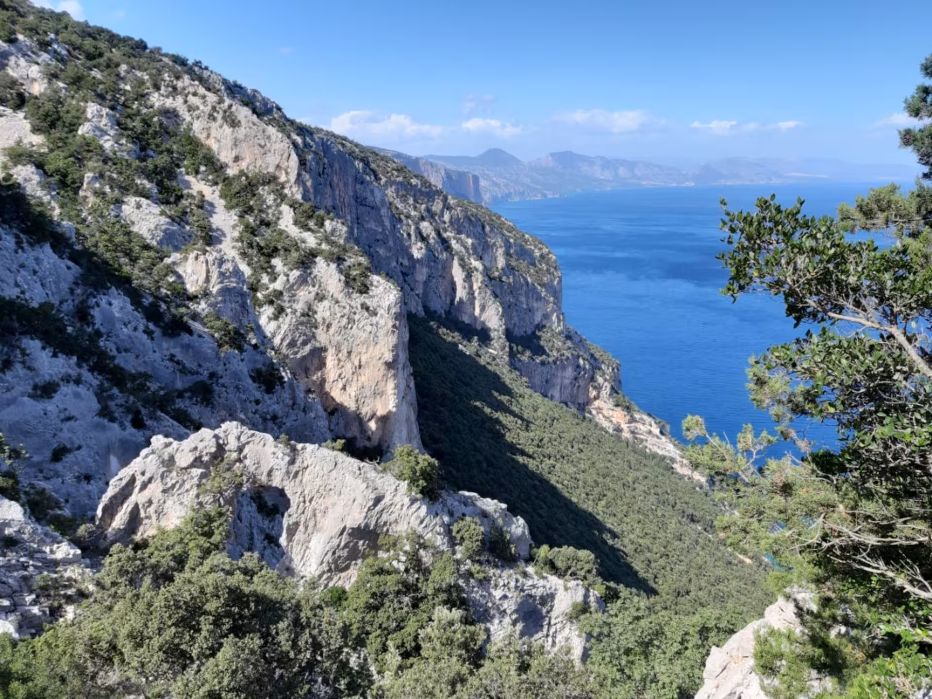 Stunning coastal cliffs and azure sea views on the scenic trek from Baunei to Cala Mariolu.