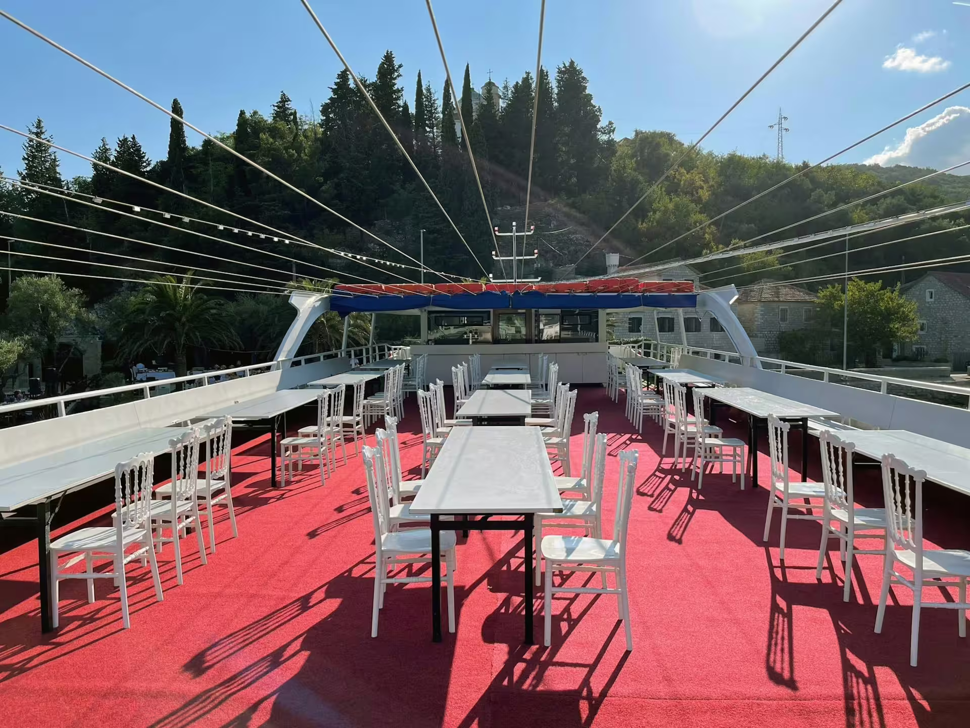 Open-air cruise boat deck seating on Bay of Kotor day trip from Dubrovnik, Montenegro fjord scenery