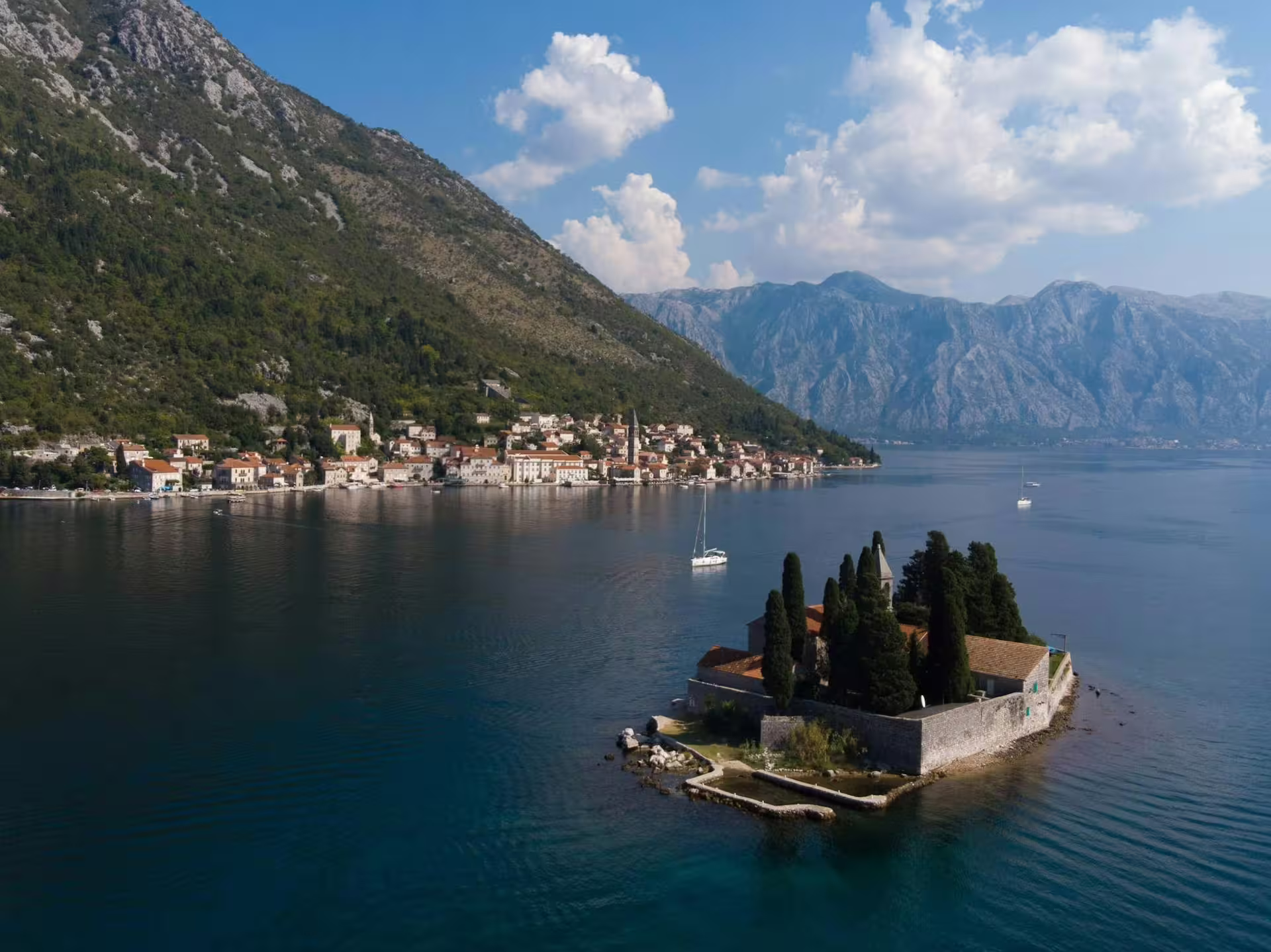 Scenic Bay of Kotor cruise from Dubrovnik passing Saint George Island near Perast, Montenegro coastline
