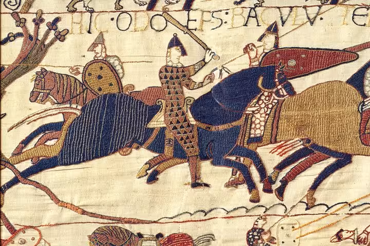 Bayeux Tapestry detail showing Norman knights on horseback in battle scene with Latin inscription