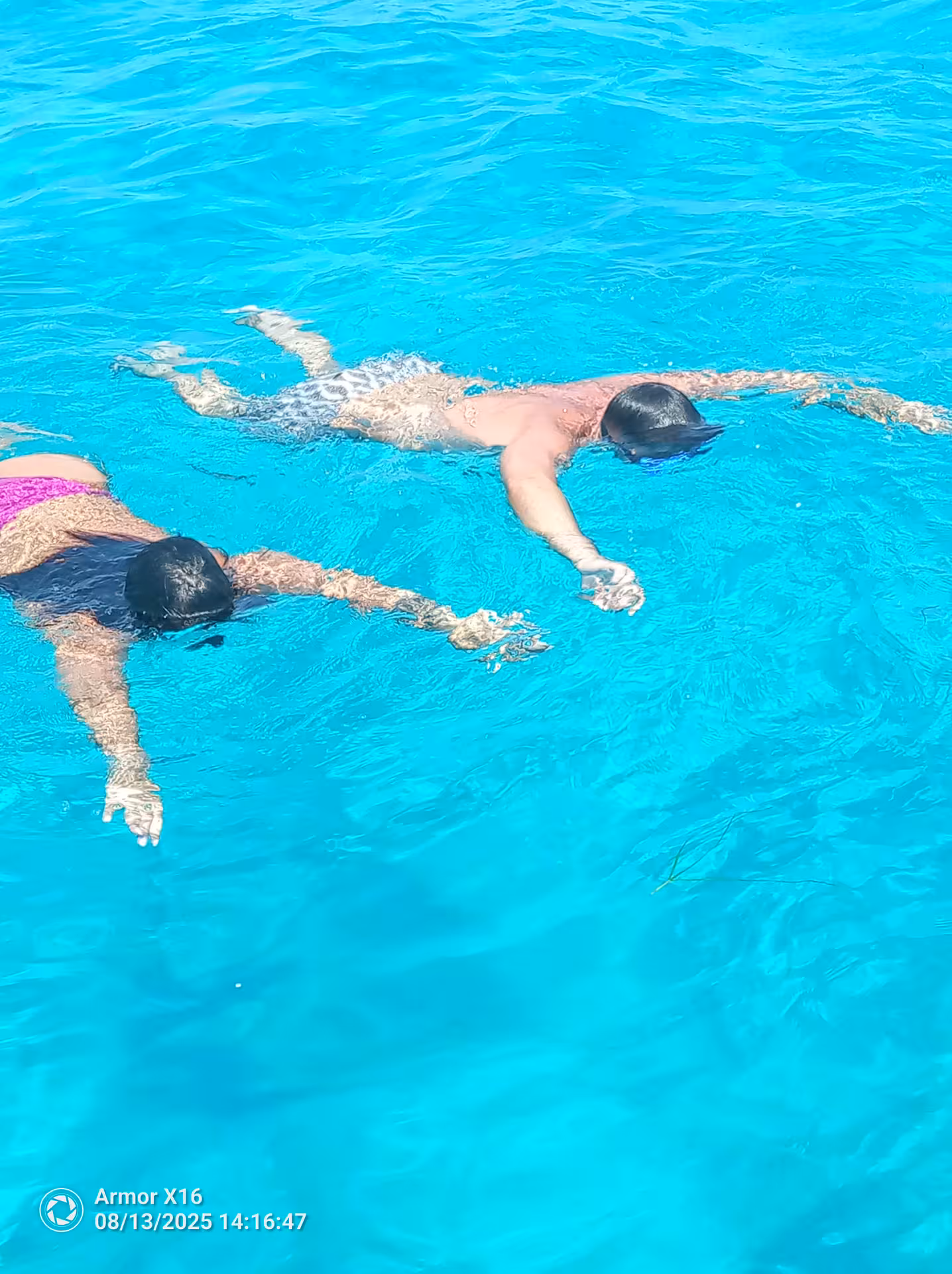 Snorkellers floating in crystal-clear turquoise water during a 2-hour Bayliner M17 cave and snorkelling trip