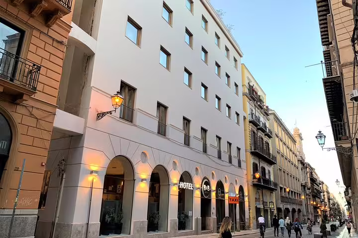 Street view of B&B Hotels Palermo Quattro Canti near Palermo Airport transfer pickup, modern facade on lively historic avenue