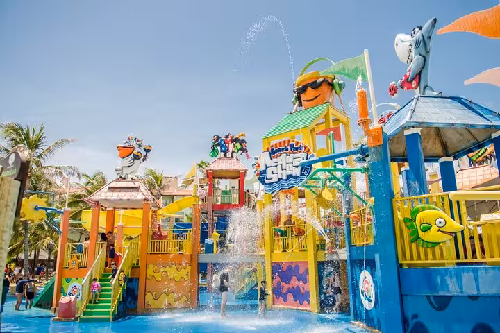 Colorful kids splash area at Beach Park Fortaleza with water jets and play towers, easy family transfer option
