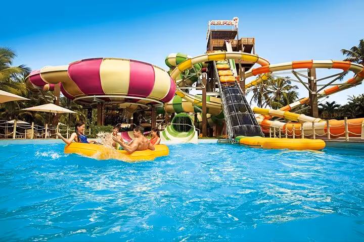 Guests on a float in Beach Park Fortaleza with colorful water slides, perfect for round-trip transfer service