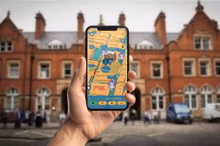Hand holding smartphone displaying Beatles walking tour mobile game map in front of historic London building