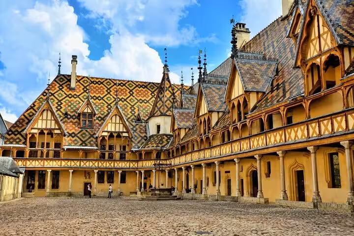 Colorful geometric tiled rooftops of Hôtel-Dieu de Beaune courtyard, Burgundy, France