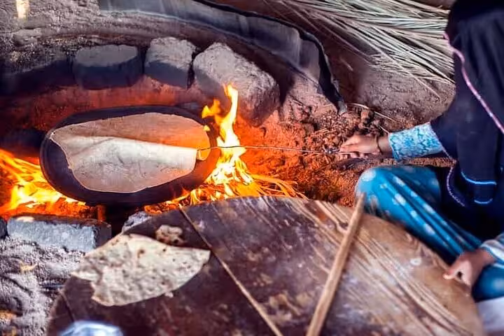 Bedouin bread baking over campfire during Super Safari quad tour dinner show from Sharm El Sheikh