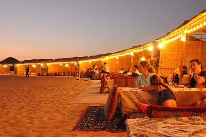 Bedouin camp dinner in Hurghada desert with lantern lights and seating, included in ATV quad and camel tour