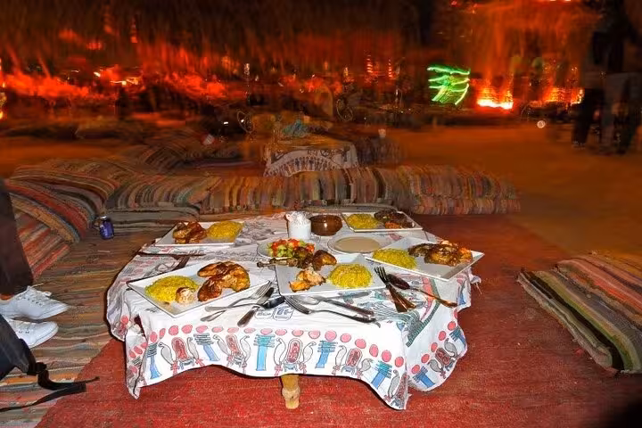 Bedouin-style desert dinner setup after private ATV quad tour from Sharm El Sheikh, with traditional food before star watching