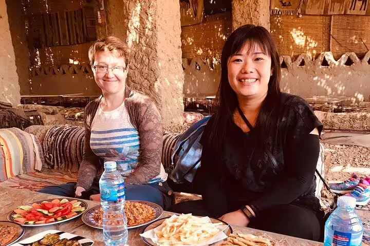 Tourists enjoying traditional Bedouin lunch in Bahariya Oasis on 3 days 2 nights White Desert safari