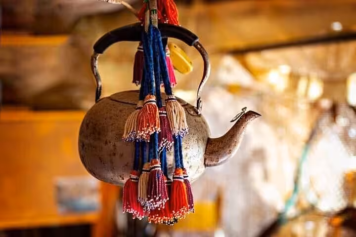 Bedouin tea kettle with colorful tassels at desert camp, Super Safari Sharm dinner and show