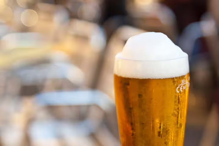 Refreshing beer in a sunlit outdoor setting, perfect for unwinding after a day exploring Lucerne and Mt. Pilatus.
