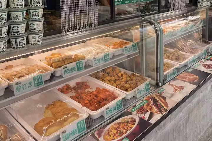 A vibrant display of diverse local snacks at a Beijing food market, showcasing authentic culinary delights.