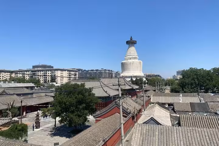Scenic view of Beijing's White Pagoda and traditional architecture during a sidecar food tour.