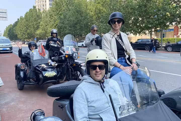 Tourists ready for adventure on a sidecar motorcycle tour through Beijing's vibrant streets and scenic routes.