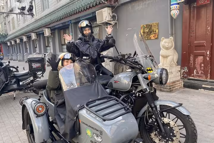 Ride through historic Beijing alleys in a sidecar motorcycle for an unforgettable daytime or nighttime adventure.