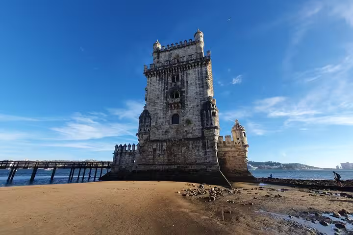 Belem Tower in Lisbon, Portugal, on a sunny day, showcasing its historic architecture and waterfront location.