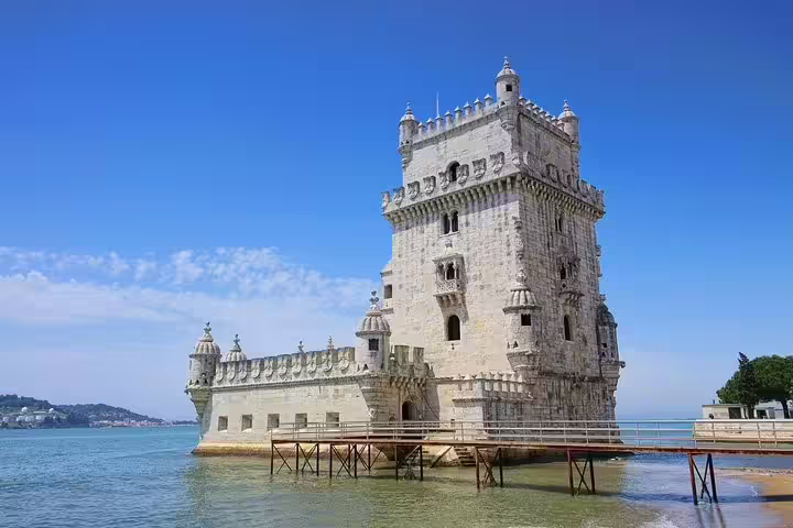 Historic Belém Tower in Lisbon, a highlight of the full-day private tour to Sintra and Lisbon, set against a clear blue sky.