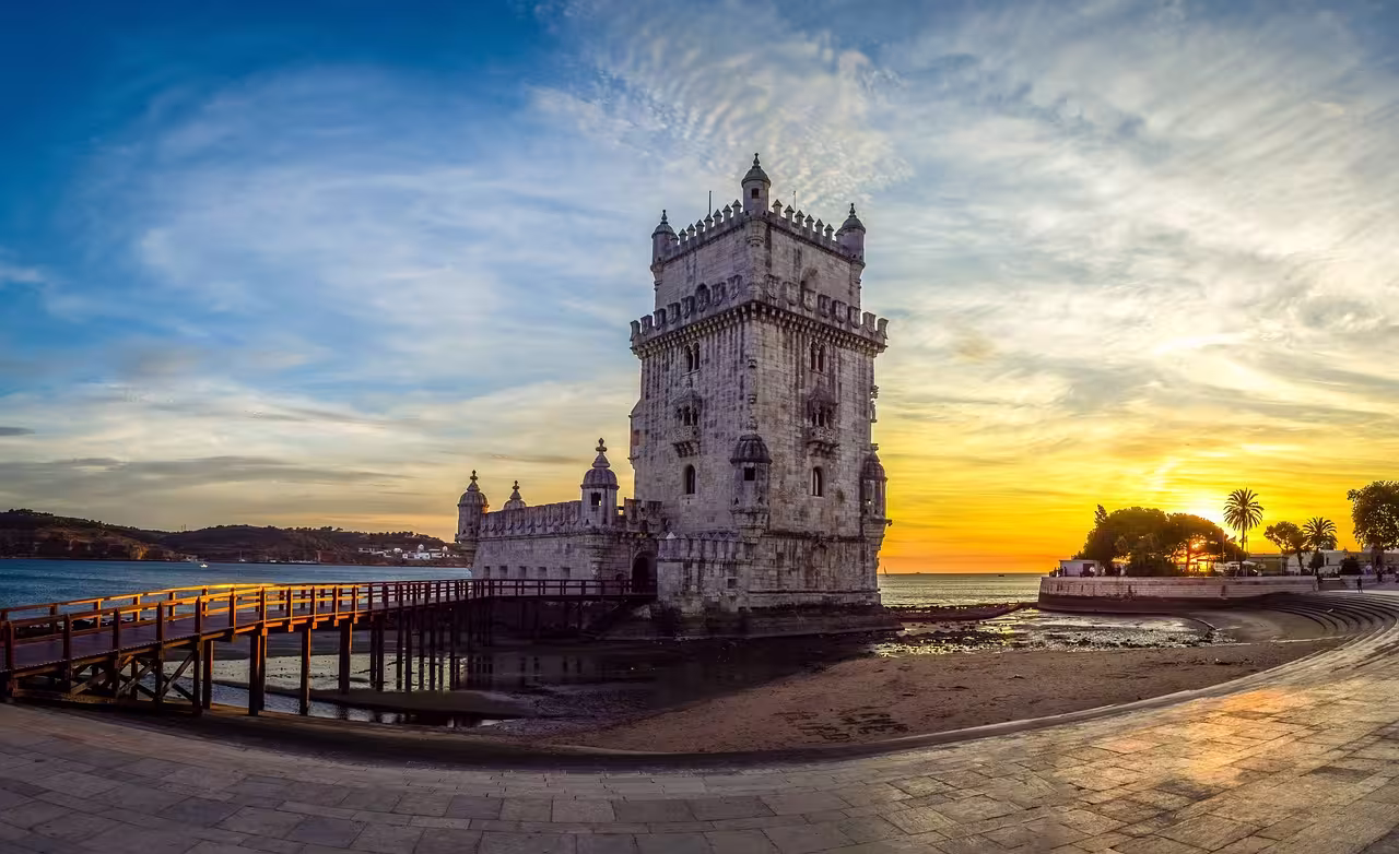 Sunset view of Belém Tower in Lisbon, highlighting its historical allure on a family-friendly day tour.