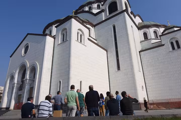 Tourists admire the grand architecture of the St. Sava Temple during a Belgrade Big Tour.