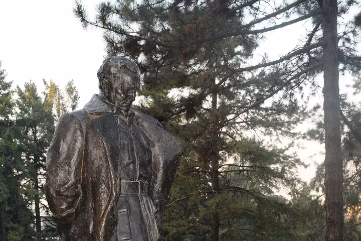 Bronze statue surrounded by lush greenery in a Belgrade park, a highlight of the Belgrade Big Tour.