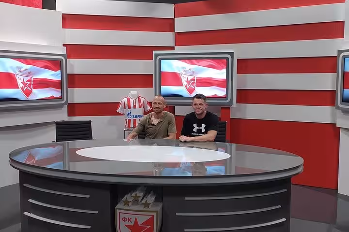 Tour guests with local host in Red Star Belgrade studio museum, part of Belgrade football match live tour