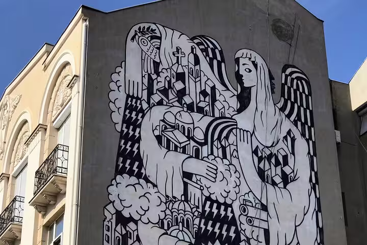 Giant black-and-white angel mural on Belgrade building, highlight of private street art walking tour