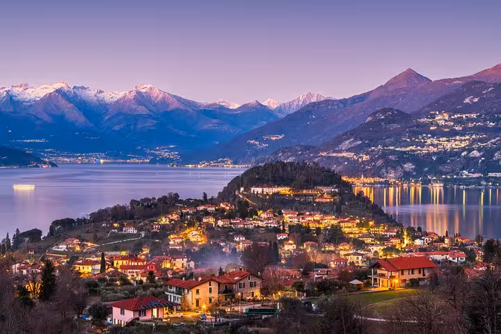Bellagio village lights at sunset on Lake Como, featured on the guided tour with lake cruise from Como