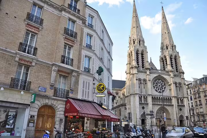 Gothic church spires and Parisian street with flower shop in Belleville neighborhood, Paris