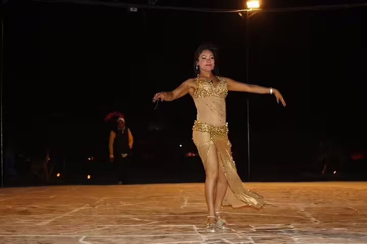 Belly dancer performing at Bedouin desert dinner show on Marsa Alam ATV quad bike and camel ride tour