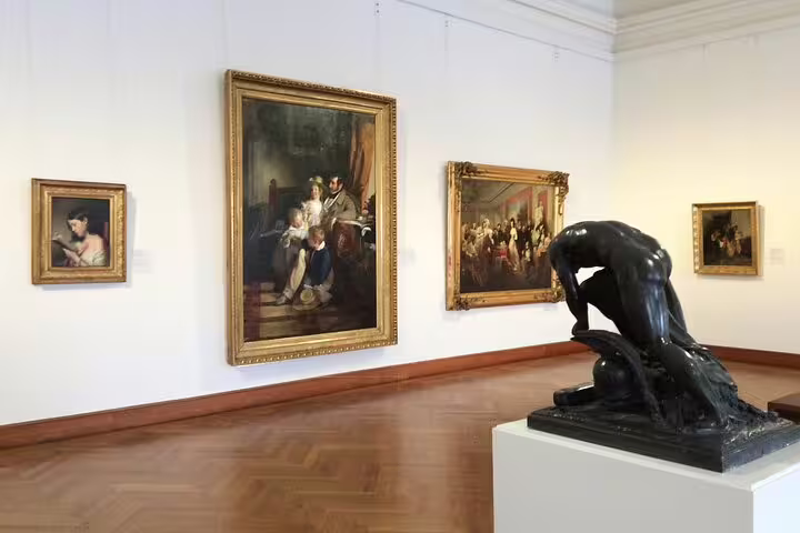 Gallery room at Belvedere Palace featuring classic paintings and sculptures, perfect for an art historian-led tour.