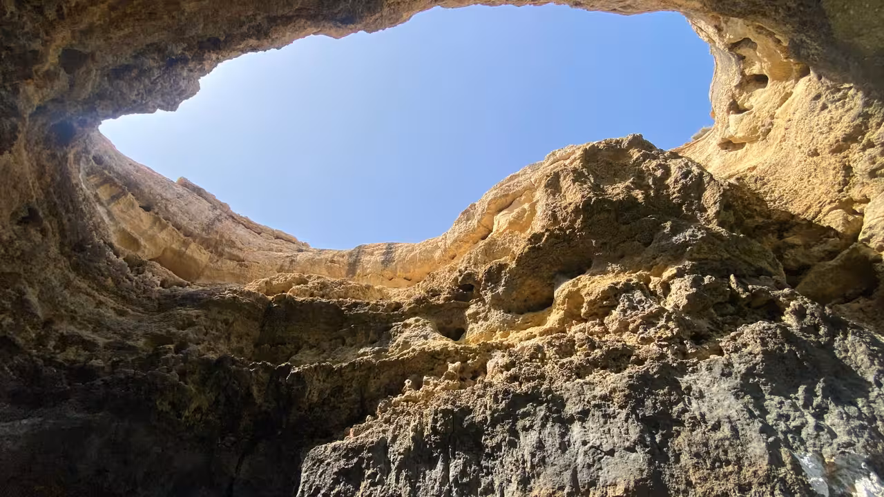 View up to Benagil Cave skylight on Algarve coast, iconic sea cave stop on private boat charter tour