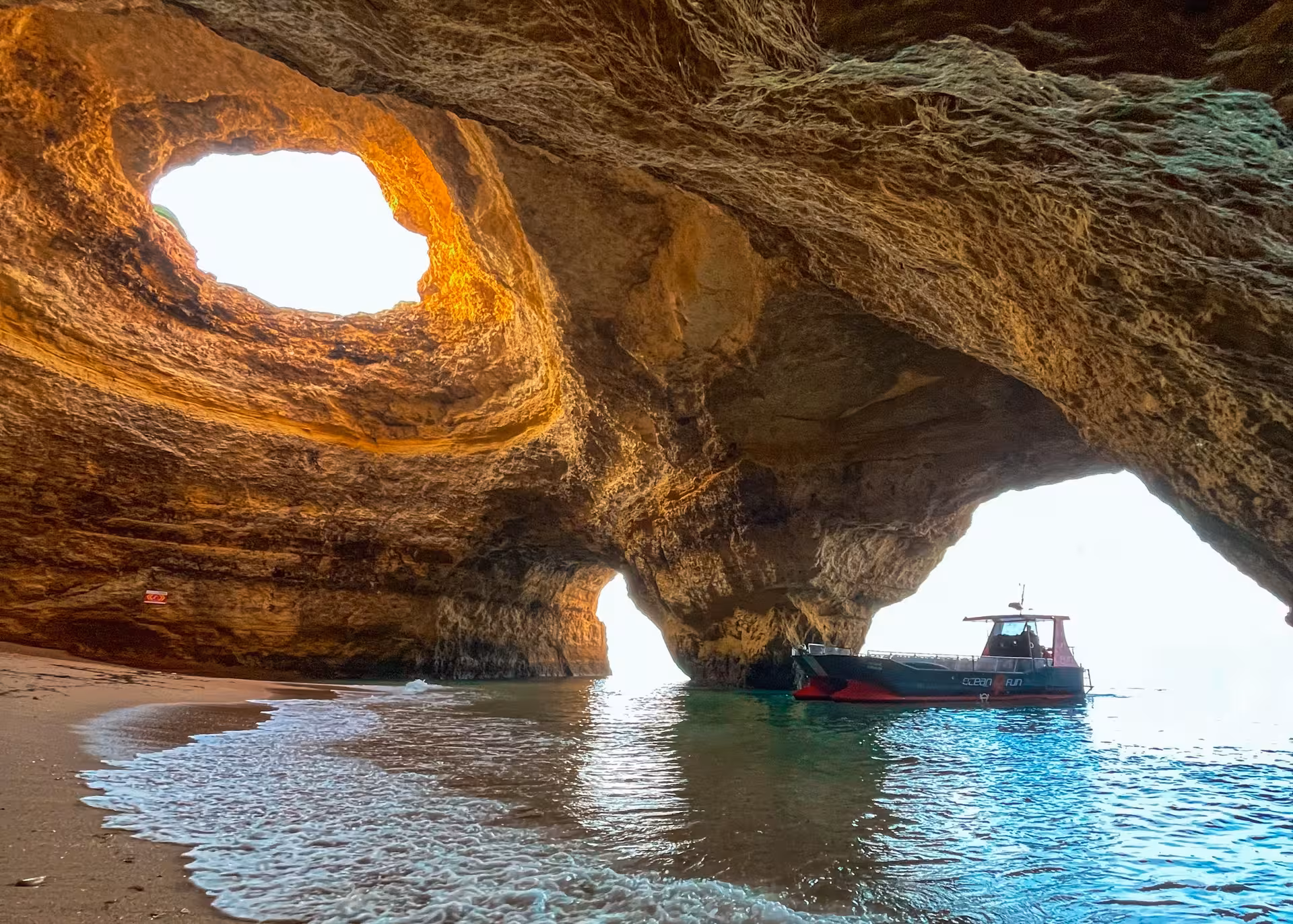 Ocean 4 Fun boat inside breathtaking Benagil sea cave on scenic Algarve catamaran tour from Portimao