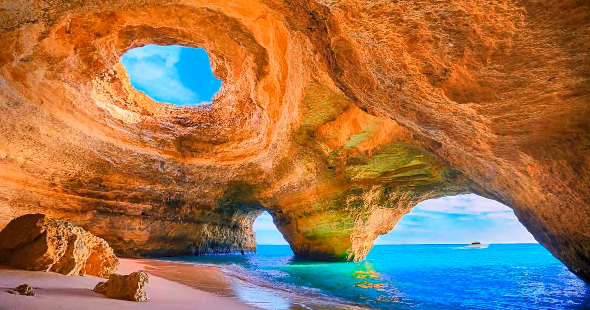 Discover the iconic Benagil Cave's magnificent arches and sandy beach on a scenic boat tour in Algarve.