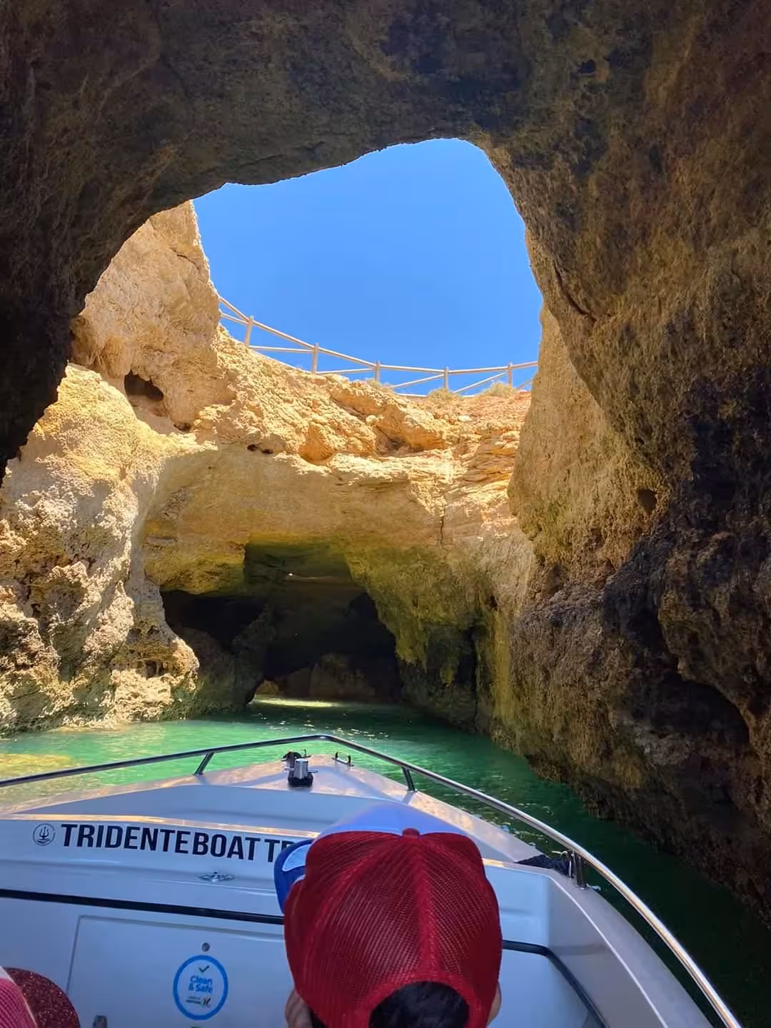 View from inside Benagil Cave boat tour showing iconic skylight opening and emerald green waters in Algarve Portugal