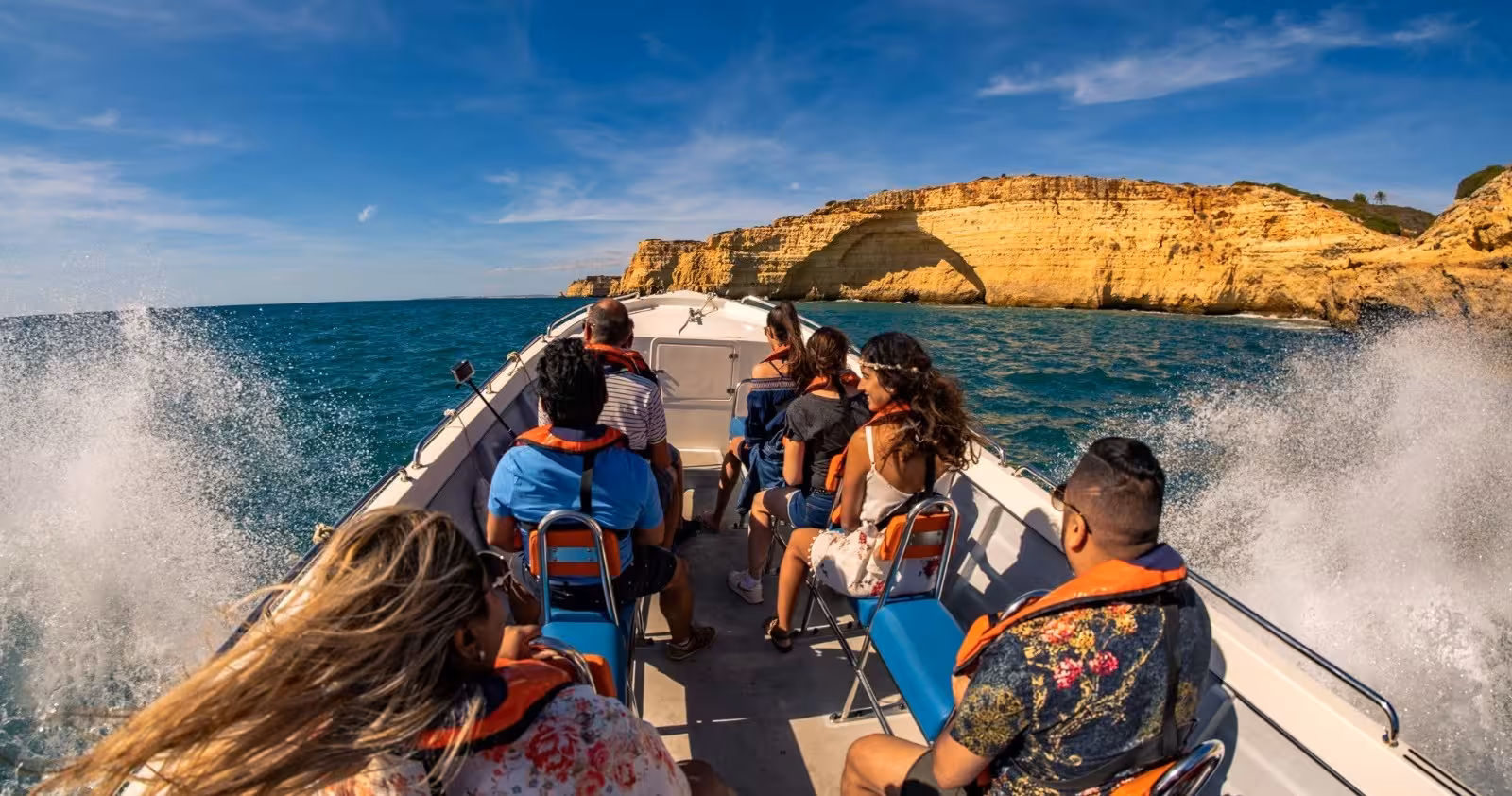 Tourists enjoy a thrilling boat ride approaching Benagil Cave from Portimão on a sunny day.