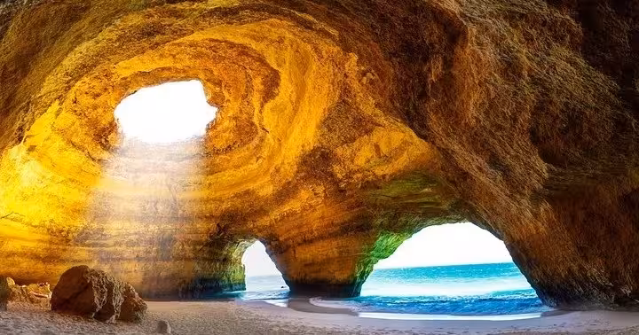 Stunning golden rock arch of Benagil Cave with turquoise sea views on Algarve boat tour
