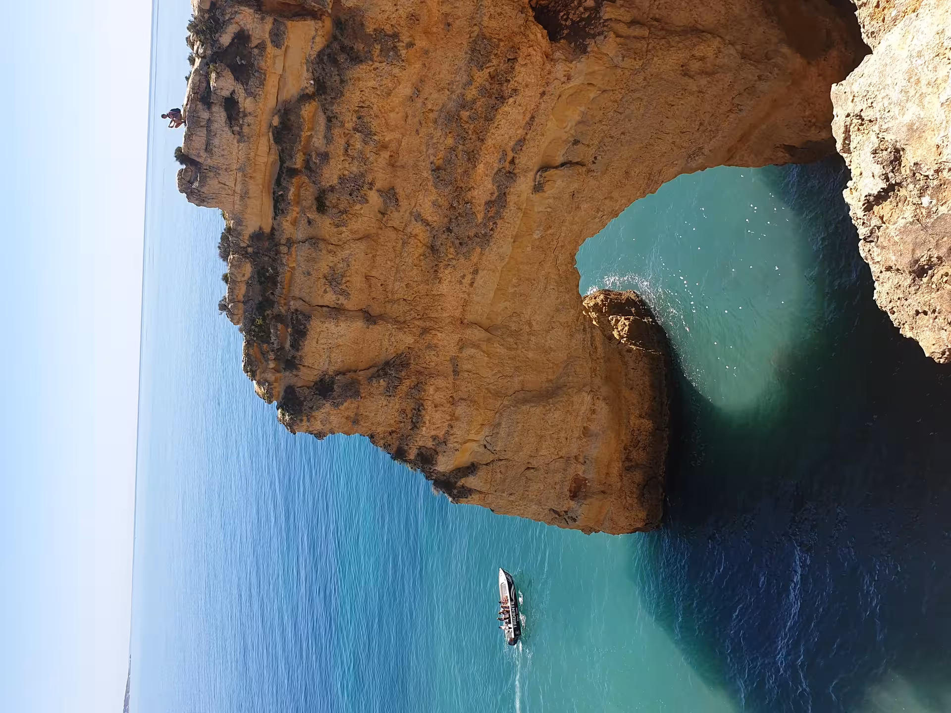 Private boat tour near Benagil Cave golden limestone cliffs and turquoise Algarve waters from Armacao de Pera