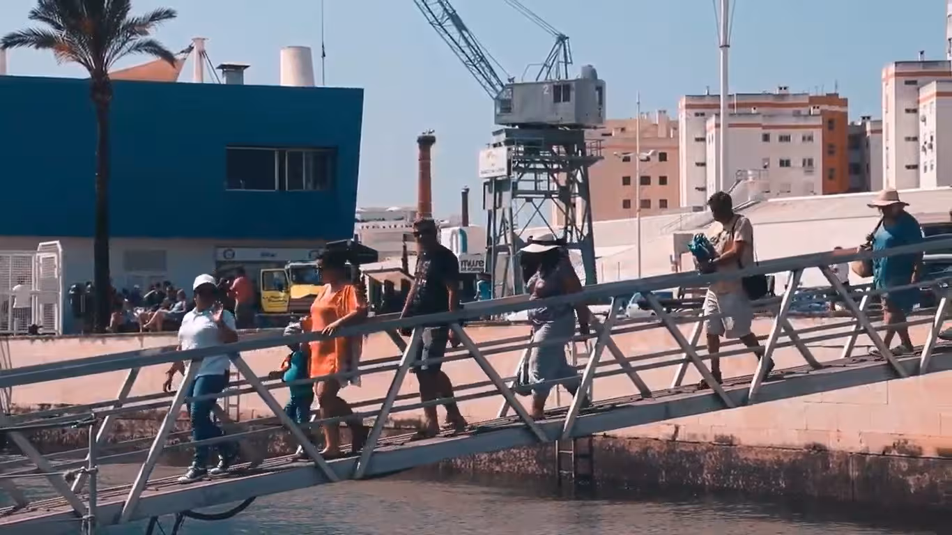 Visitors walk along a dock in Portimão, preparing for a captivating Benagil Cave tour, showcasing Algarve's maritime charm.