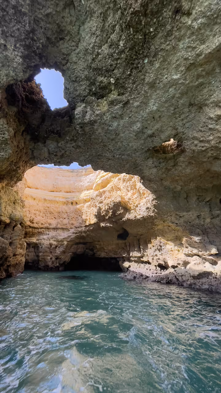 Inside Benagil sea cave with turquoise water and skylight, Algarve private charter boat coastline tour