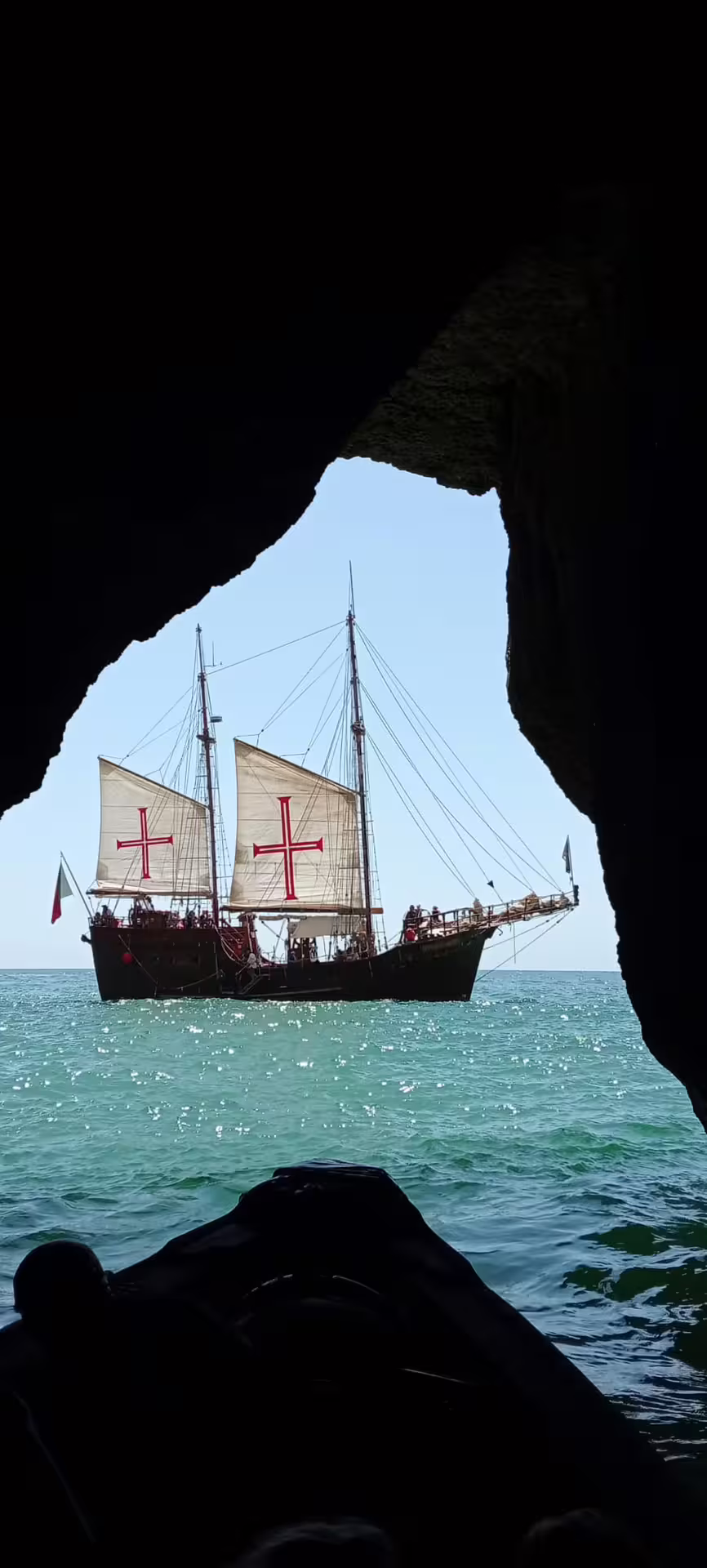 Explore the stunning Benagil Caves with a view of a classic sailing ship on the turquoise sea during our afternoon cruise.