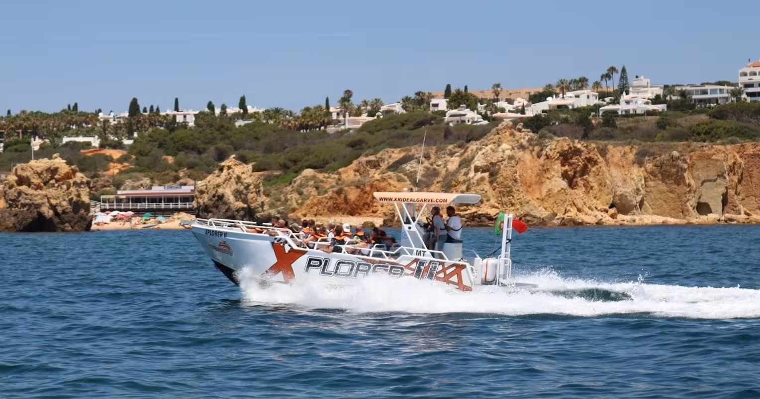 Xplorer II speedboat racing along Algarve coastline with guests on a Benagil caves dolphin watching cruise