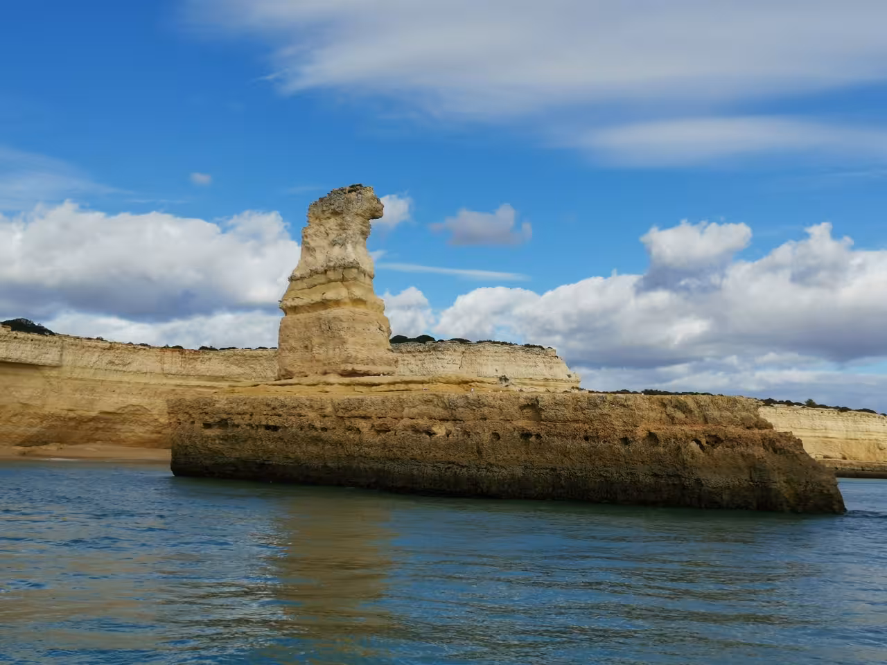 Algarve limestone sea stack and cliffs on the Benagil coastal boat trip from Albufeira Marina, Portugal