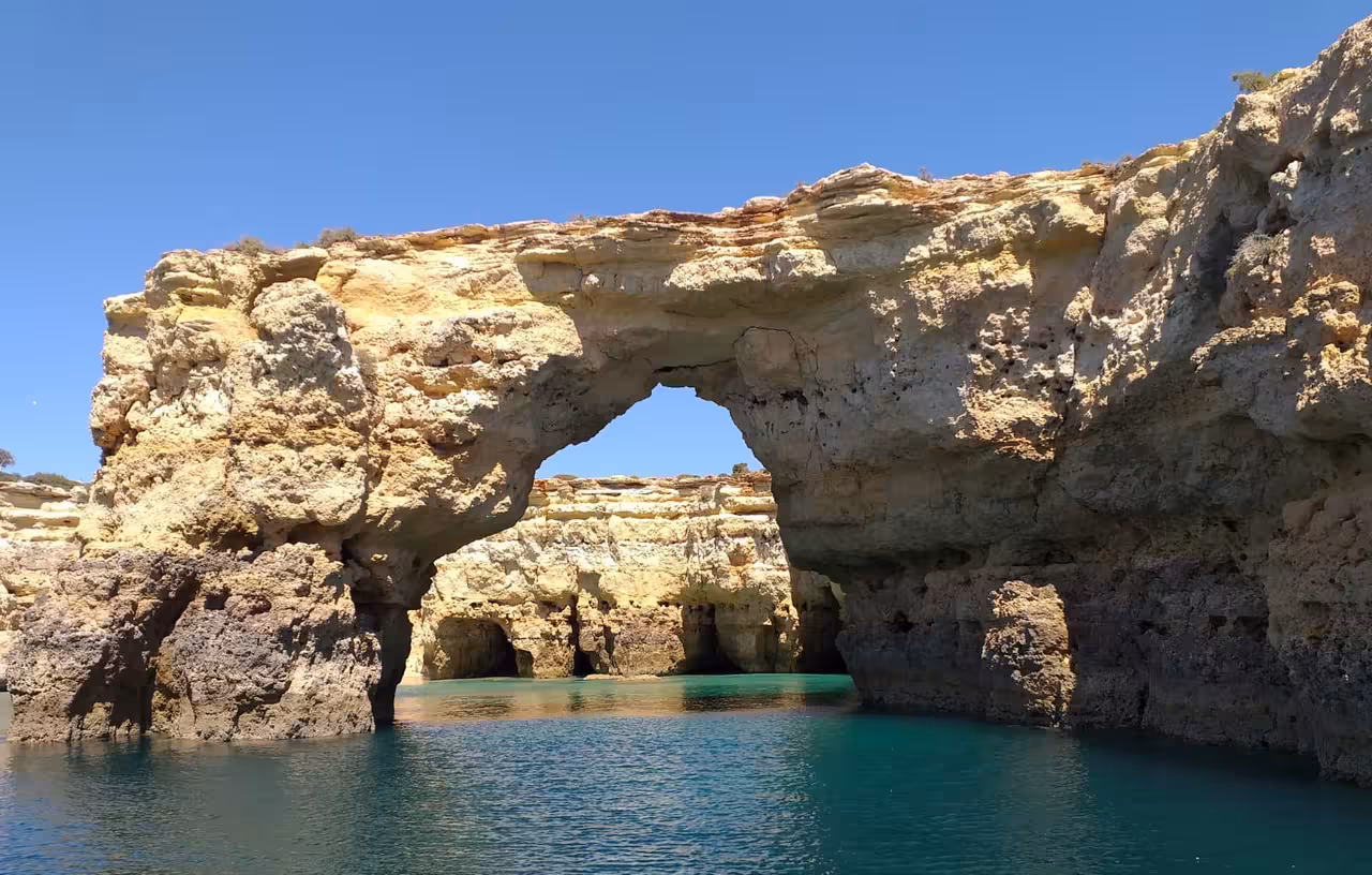 Algarve coastal rock arch near Benagil on scenic boat cruise from Albufeira Marina, turquoise water and cliffs