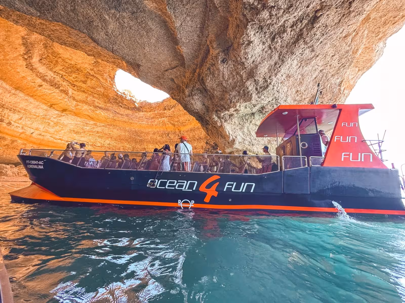 Ocean 4 Fun tour boat filled with guests exploring the iconic Benagil sea cave on an Algarve coast cruise